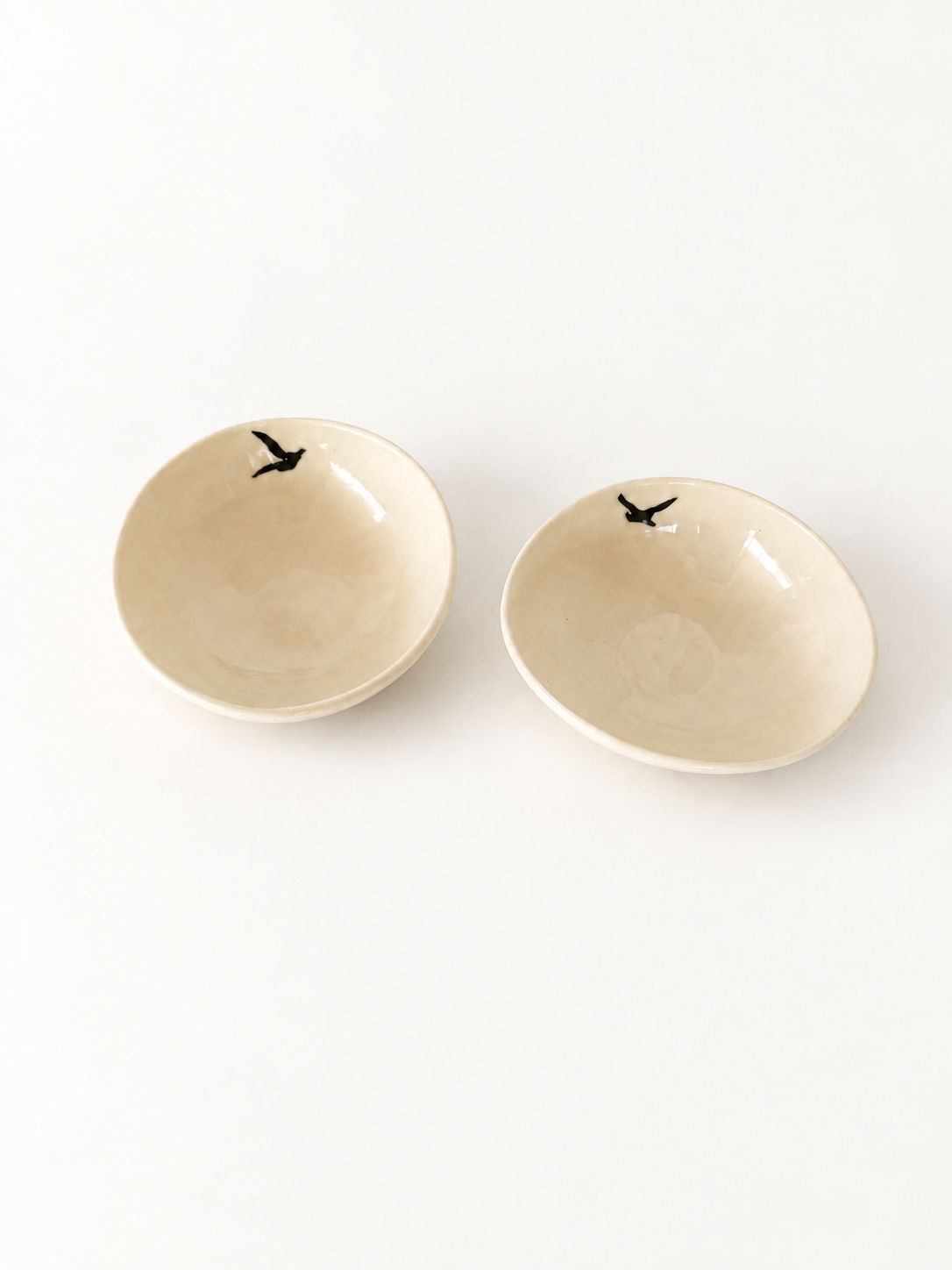 Angled view of two handmade Birds Mezze Bowls