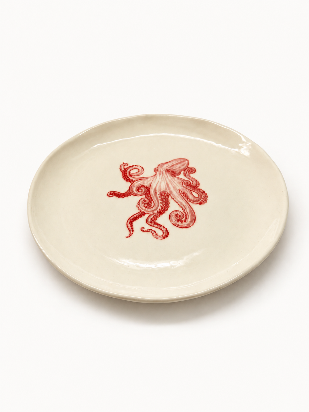Angled view of handmade ivory octopus plate, approximately 26 cm