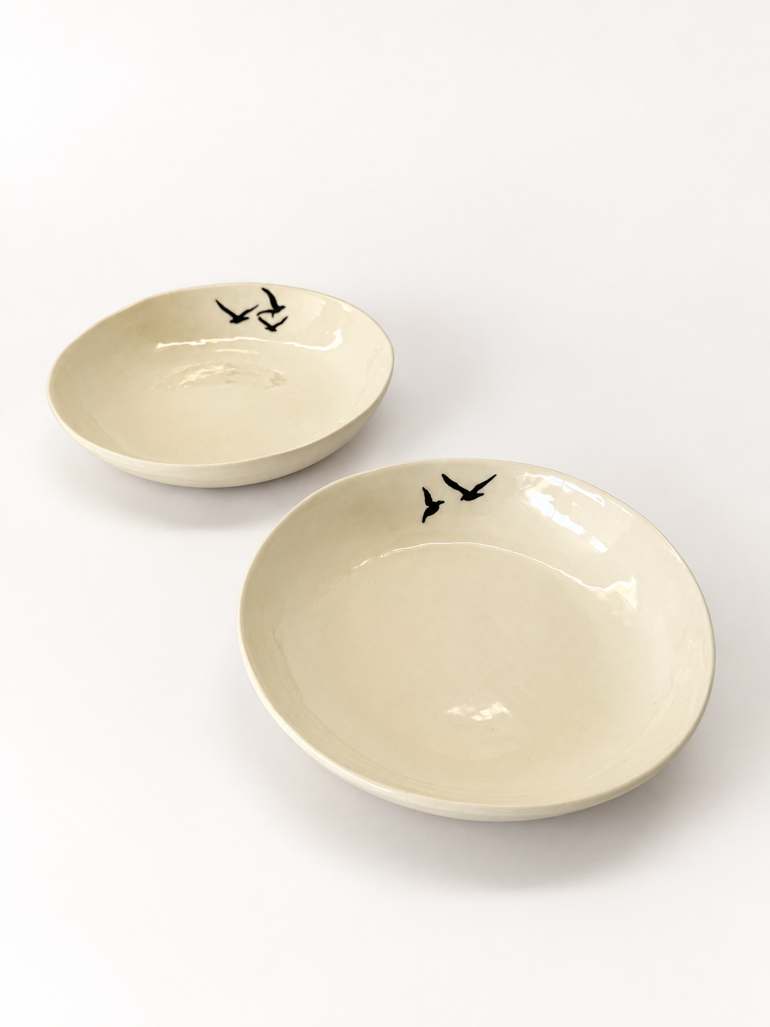 Angled view of two handmade Birds Pasta Bowls