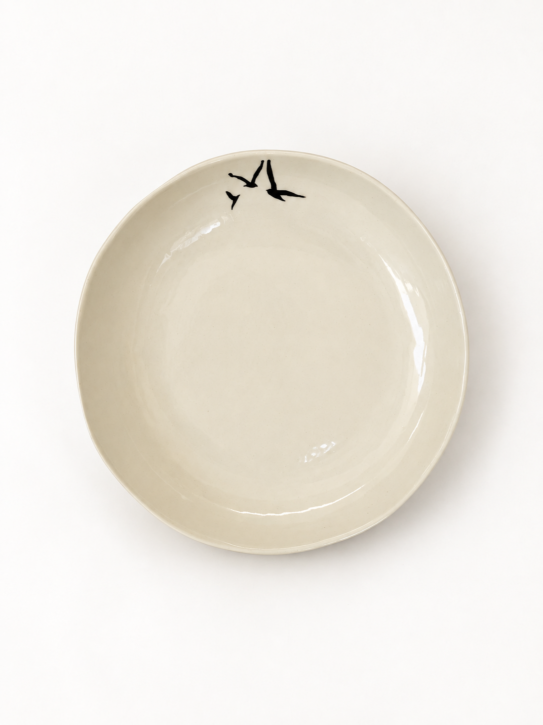 Top view of handmade ivory Birds Serving Bowl with three black birds